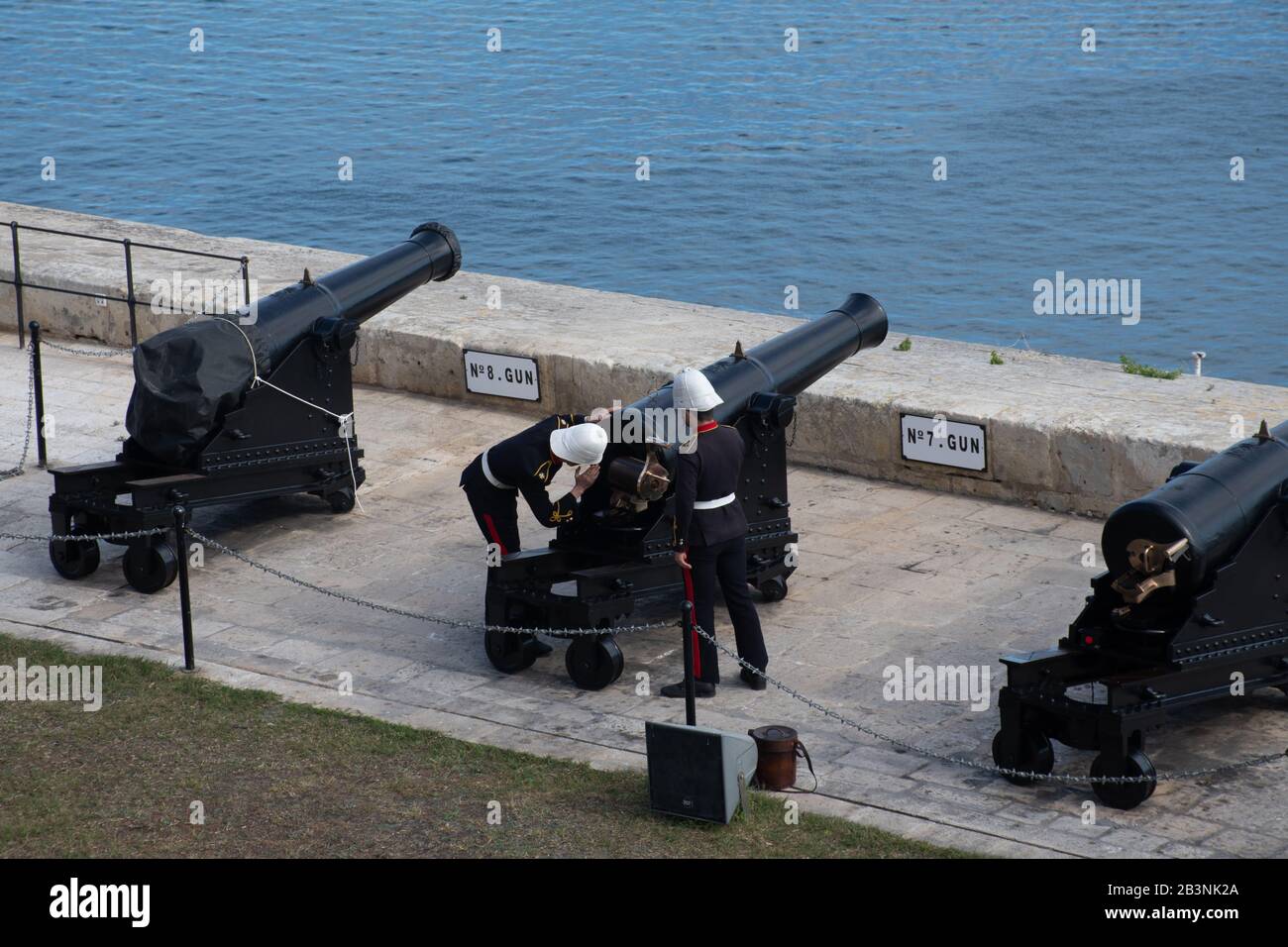 Valleta Malta - 8. Februar 2020: Soldaten, die sich darauf vorbereiten, Kanone mit den Upper Barakka Gardens im Hintergrund zu feuern Stockfoto