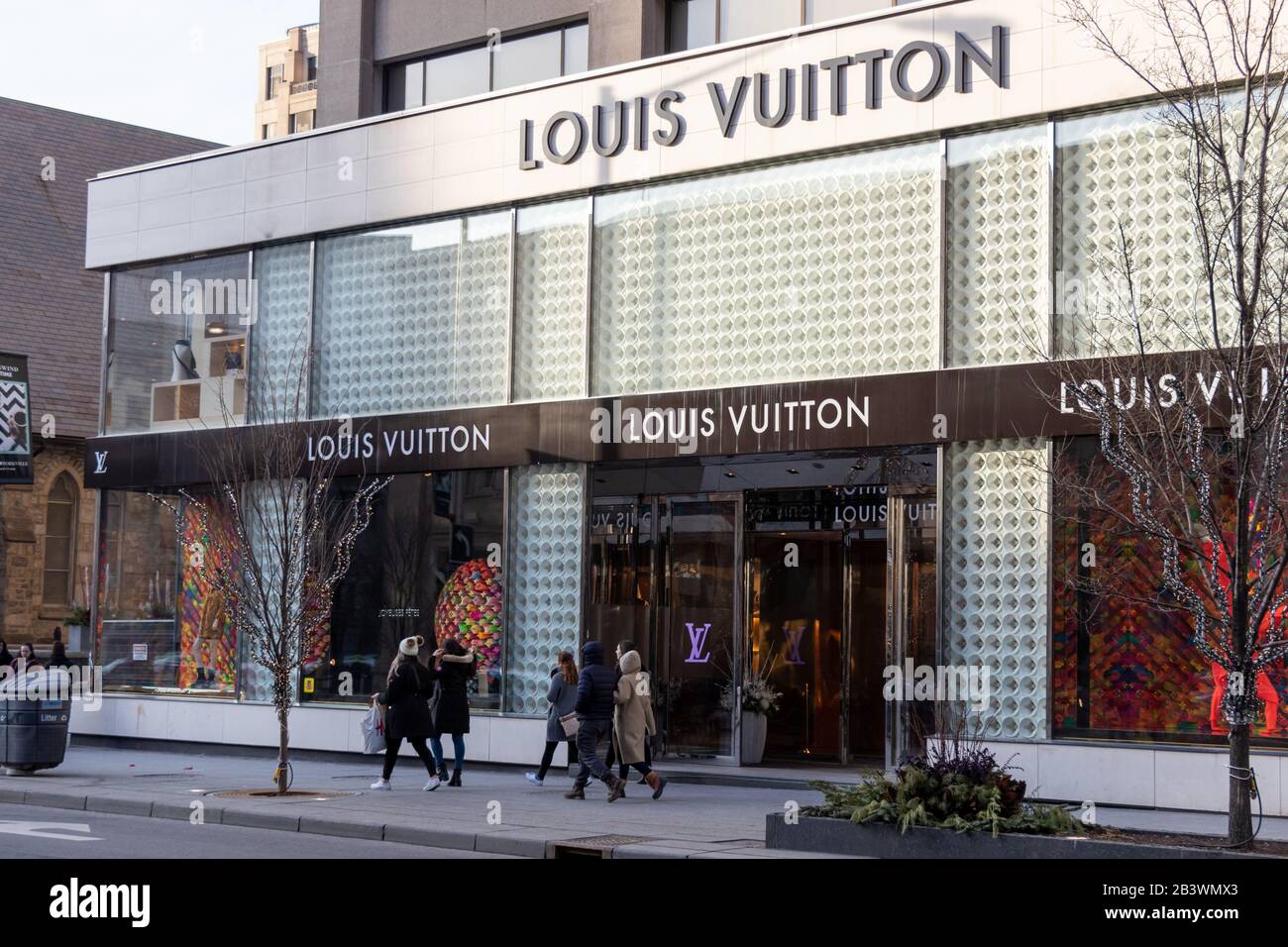 Louis Vuitton Geschäft in der Innenstadt von Toronto gesehen, wie Menschen an einem sonnigen späten Nachmittag vorbei laufen. Stockfoto