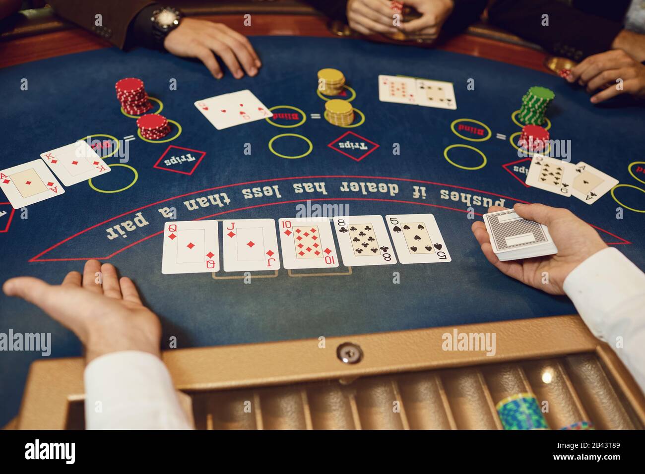 Die Hände der Spieler und die Croupiers im Spiel Karten. Stockfoto