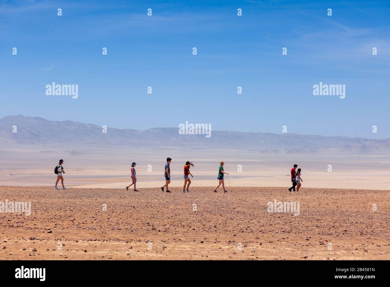 Eine Gruppe von Menschen, die in der Wüste spazieren, Paracas National Reserve, Peru. Stockfoto