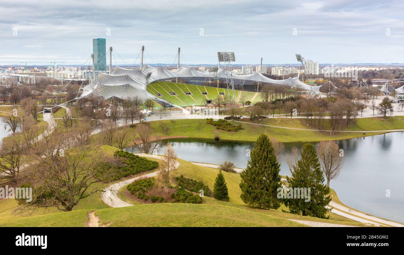 Olympiapark mit See & Olympiastadion. Eine der Hauptmerkmale des Stadions ist das einzigartige Glasdach. Entworfen von Behnisch & Partner, eingeweiht Stockfoto