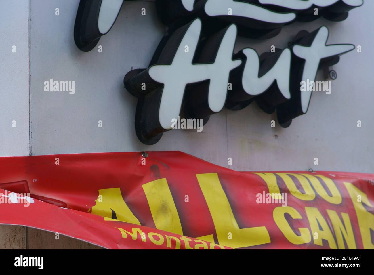 Das Closeup eines Logos und flatternde Werbeplakate der Fast-Food-Kette Pizza Hut in Bad Homburg. Stockfoto