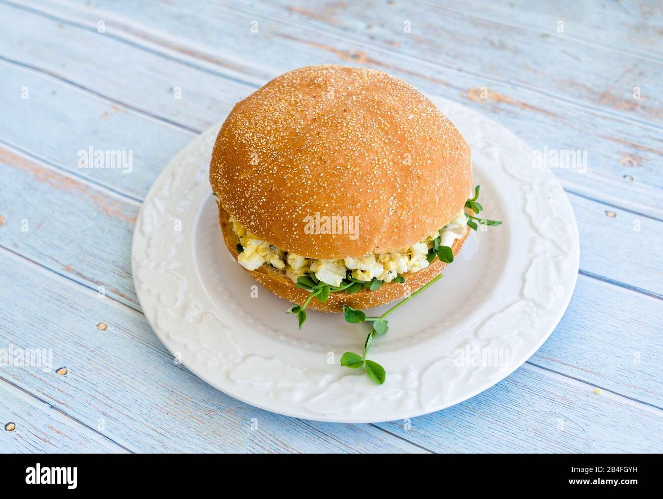 Ein Eiersalat-Sandwich auf einem Teller mit Erbsensprossen. Stockfoto