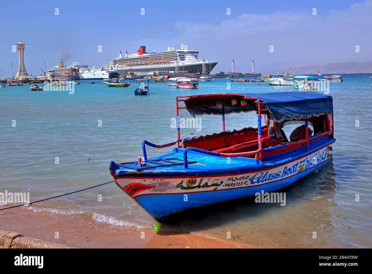 Ausflugsboot mit Kreuzfahrtschiff Queen Mary 2 im Hafen Akaba Akaba, Golf von Akaba, Rotes Meer, Jordanien Stockfoto