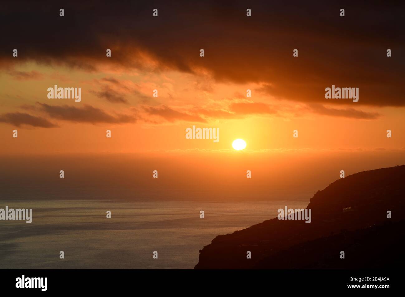 Dramatischer Wolkenhimmel bei Sonnenuntergang, Klippen bei Arco da Calheta, Insel Madeira, Portugal Stockfoto