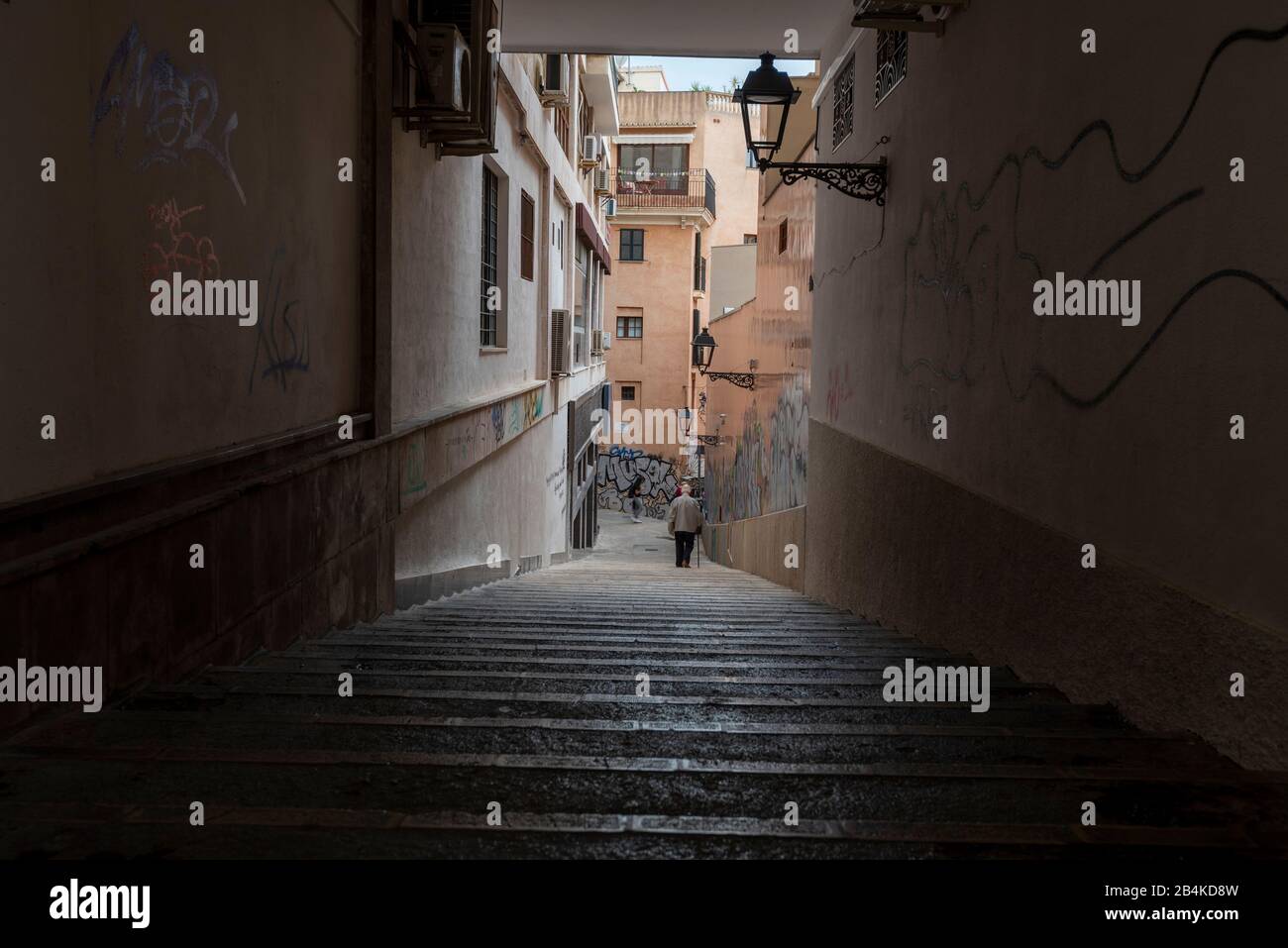 Spanien, Mallorca, Palma, ein Mann mit Rohrstock geht eine Treppe hinunter. Stockfoto