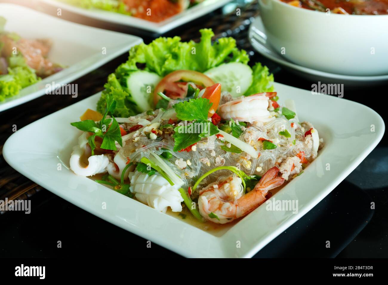 Würziger Nudelsalat, würziger Salat mit frischen Garnelen und Tintenfisch, thailändisches Essen. Hausgemachte Lebensmittel. Konzept für eine leckere und gesunde Mahlzeit Stockfoto