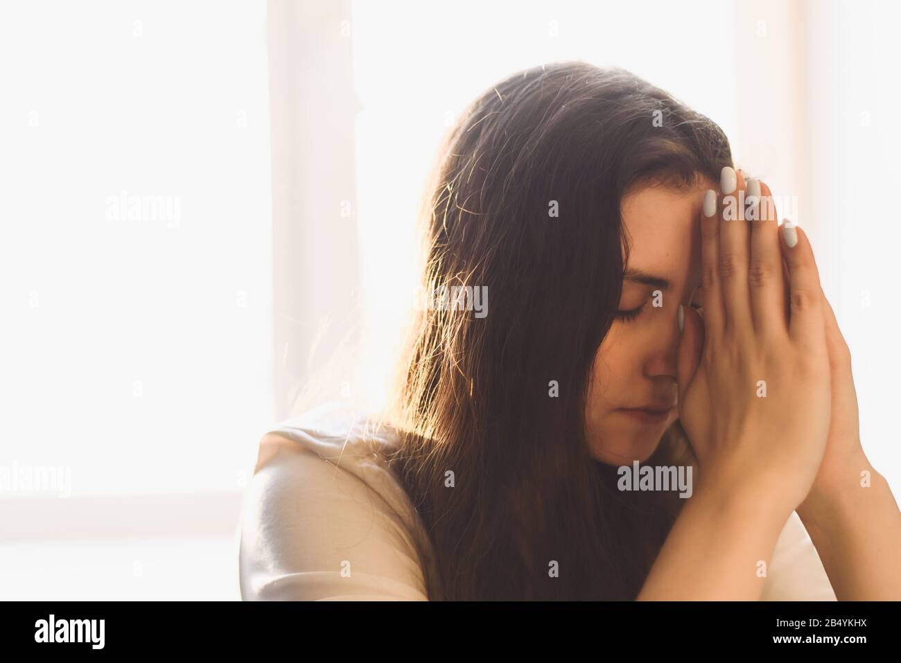 Frau übergibt sich, zu gott zu beten. Frau Bittet um Gottes Segen, um ein besseres Leben zu wünschen, um Vergebung zu bitten und an Güte zu glauben. Das christliche Lebenskrisengebet an gott. Stockfoto