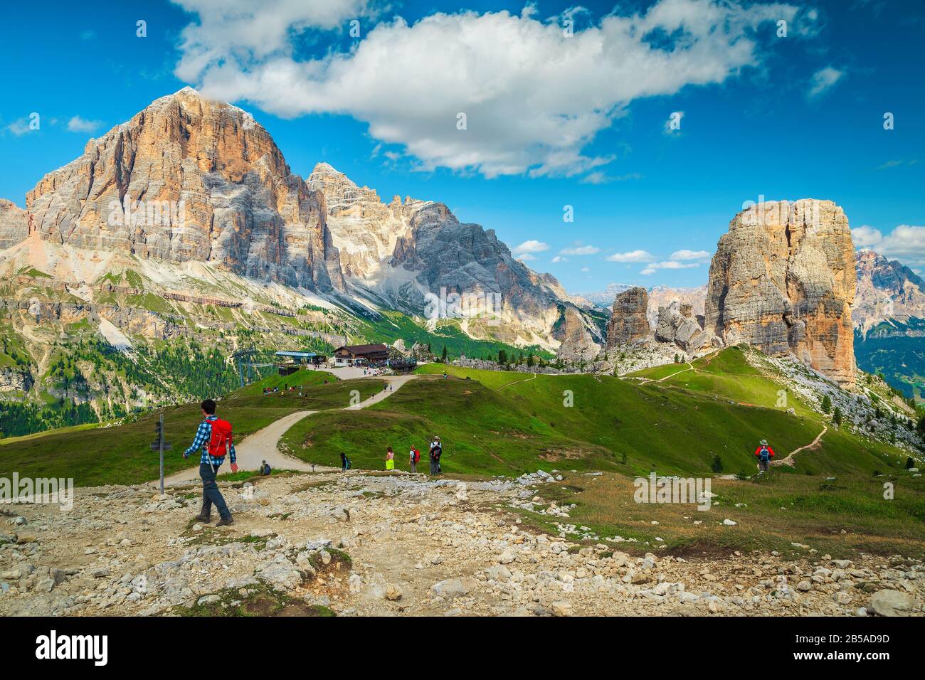 Aktive Backpacker Wanderer auf den Bergwegen in den Dolden. Sportliche Touristen mit Rucksäcken, die auf den Wanderwegen in der Nähe des Cinque Torri Rock spazieren gehen Stockfoto