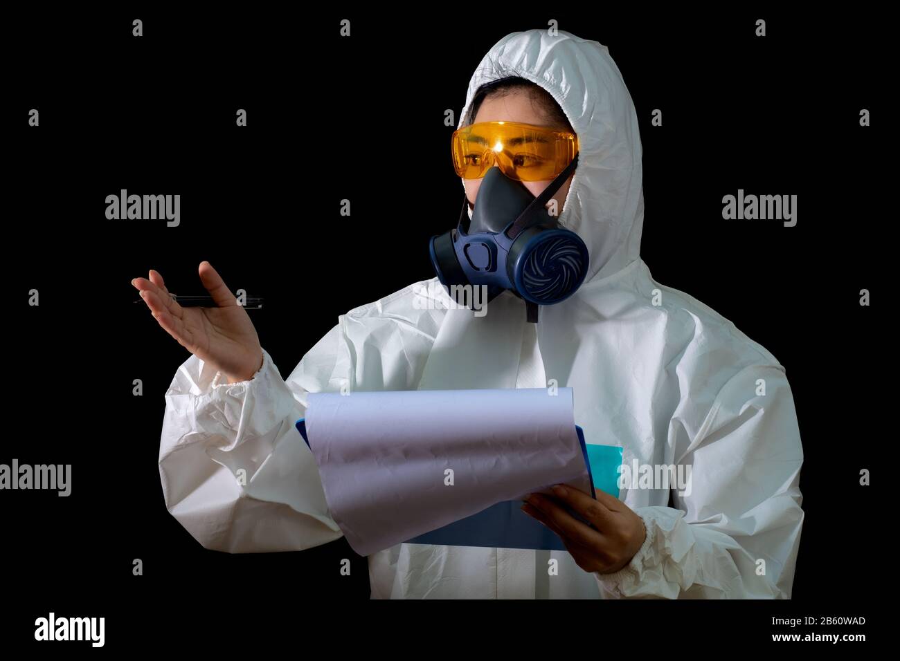 Frau hält Berichtsordner in weißer chemischer Schutzkleidung und Gasmaske mit gelber Brille am weißen Hintergrund, Wissenschaftlerin im Safet Stockfoto
