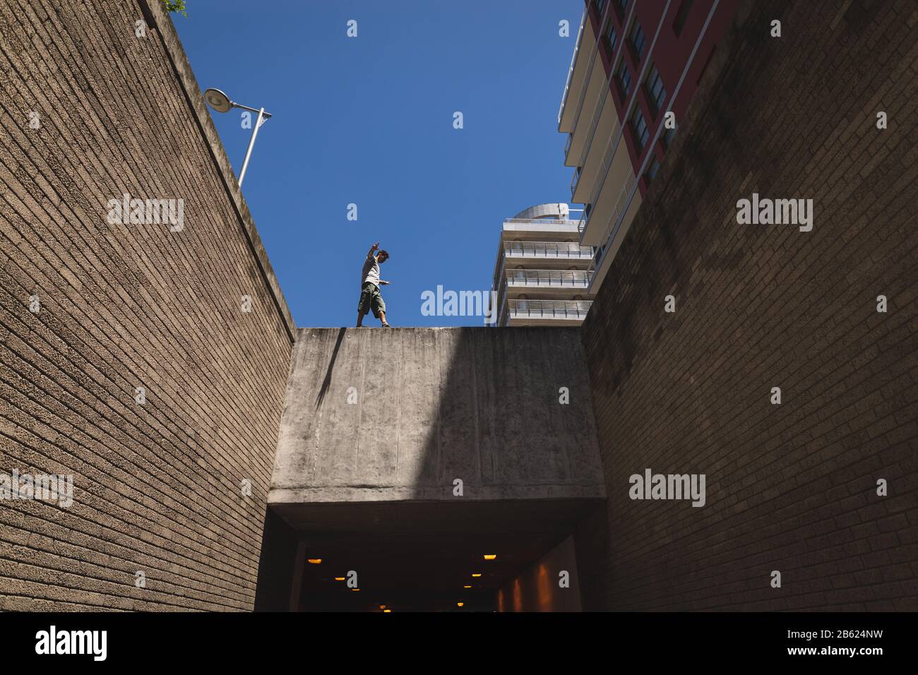 Kaukasischer Mann, der an Wänden spazieren geht Stockfoto