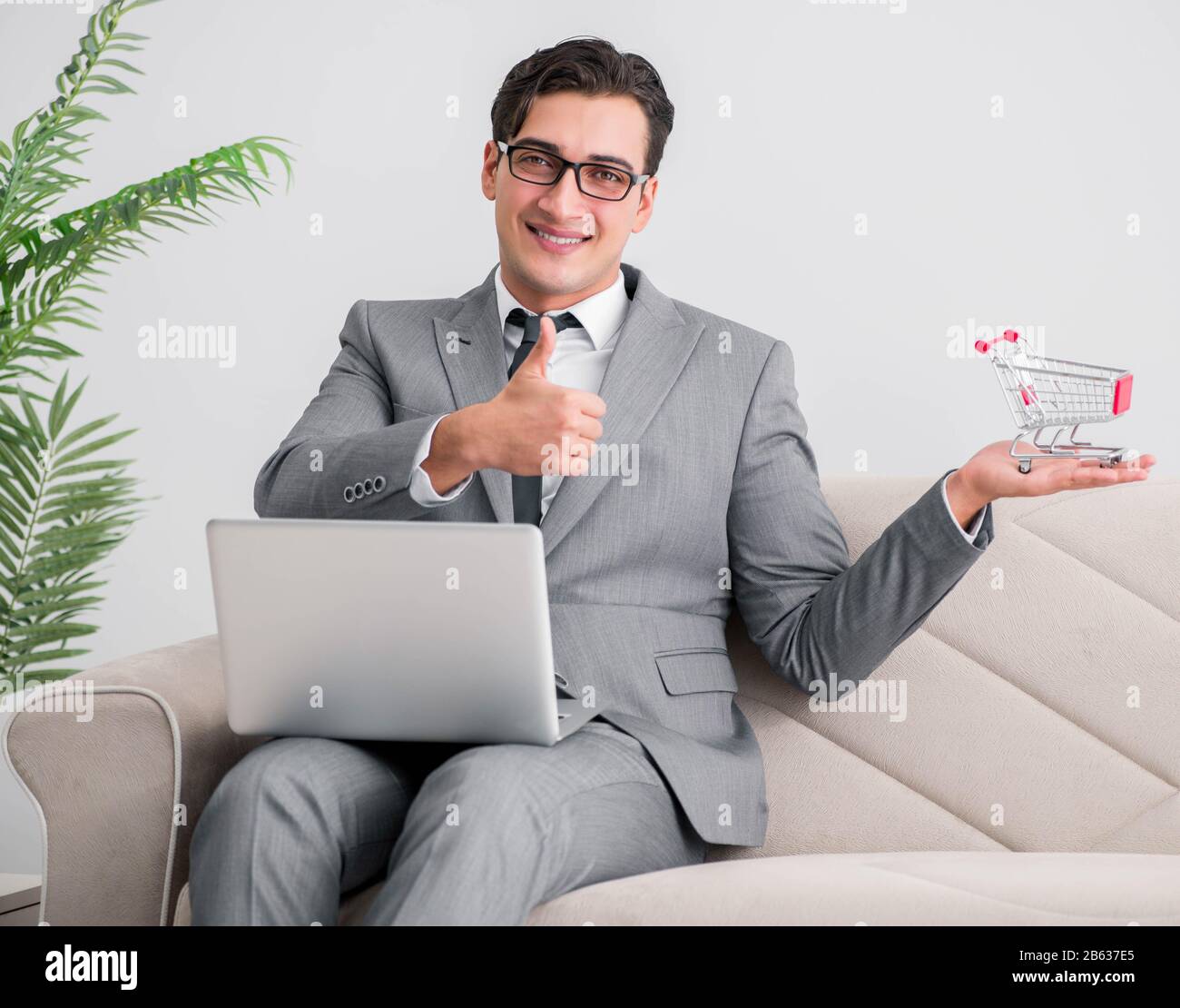 Der Geschäftsmann mit Laptop und Einkaufswagen Stockfoto