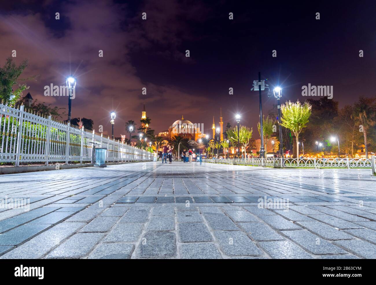 Ein Paar nimmt spät in der Nacht auf dem Sultanahmet-Platz eine selfie mit der hinter ihnen beleuchteten Hagia Sophia. Stockfoto