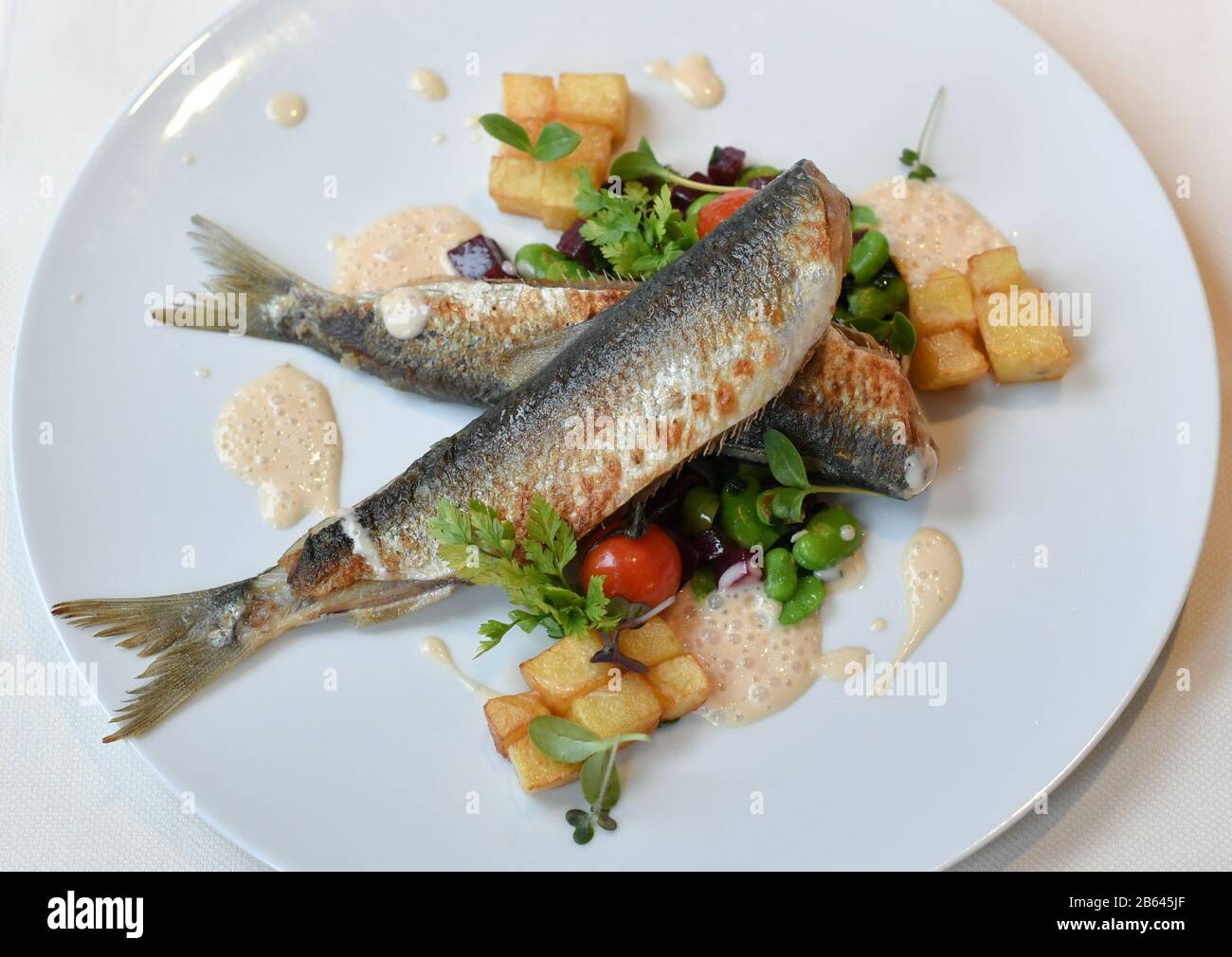 Ahlbeck, Deutschland. März 2020. Anlässlich der "Usedom-Herring-Wochen" vom 02.03. Bis 13.04.2020 werden gebratene Fischgräten mit fava-bohnen, Rote Bete und Rissolekkartoffeln im Restaurant Düne 48 im Strandhotel "das Ahlbeck Hotel & Spa" serviert. Kredit: Jens Kalaene / dpa-Zentralbild / ZB / dpa / Alamy Live News Stockfoto