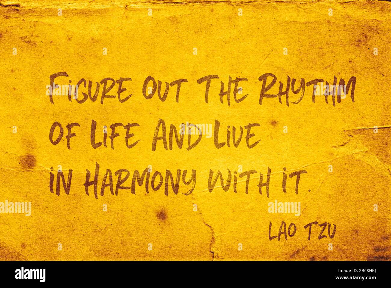 Entziffern Sie den Rhythmus des Lebens und leben Sie in Harmonie damit - das Zitat des alten chinesischen Philosophen Lao Tzu, das auf grunge gelbem Papier gedruckt ist Stockfoto