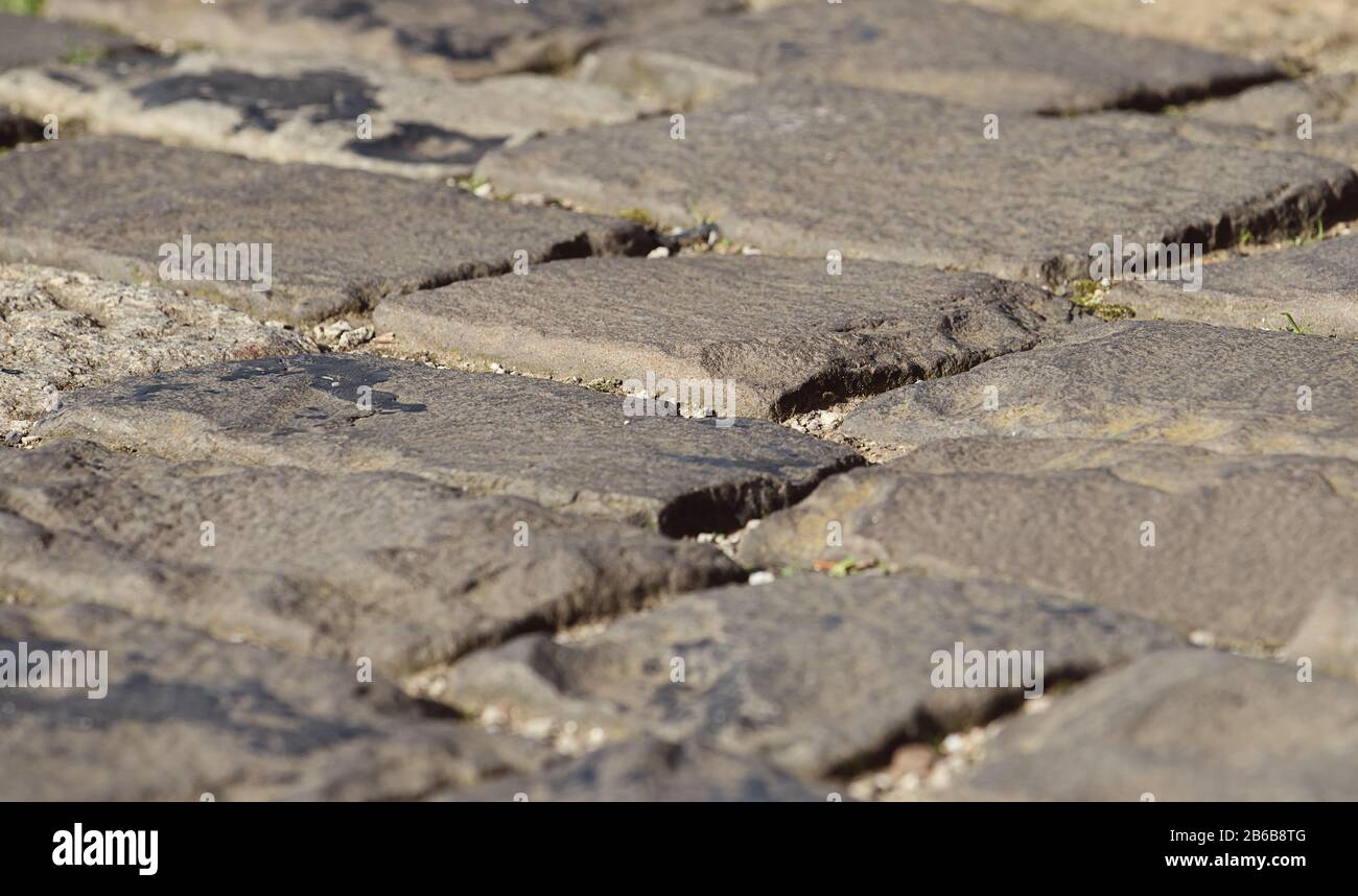 Nahaufnahme einer alten Kopfsteinpflaster-/Pflasterstraße, Hintergrund Stockfoto