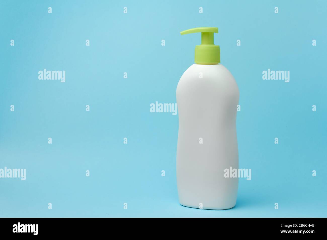 Verspotten Sie weiße Flaschen mit einem Spender auf blauem Hintergrund. Platz für Werbung für kosmetische Produkte kopieren. Stockfoto