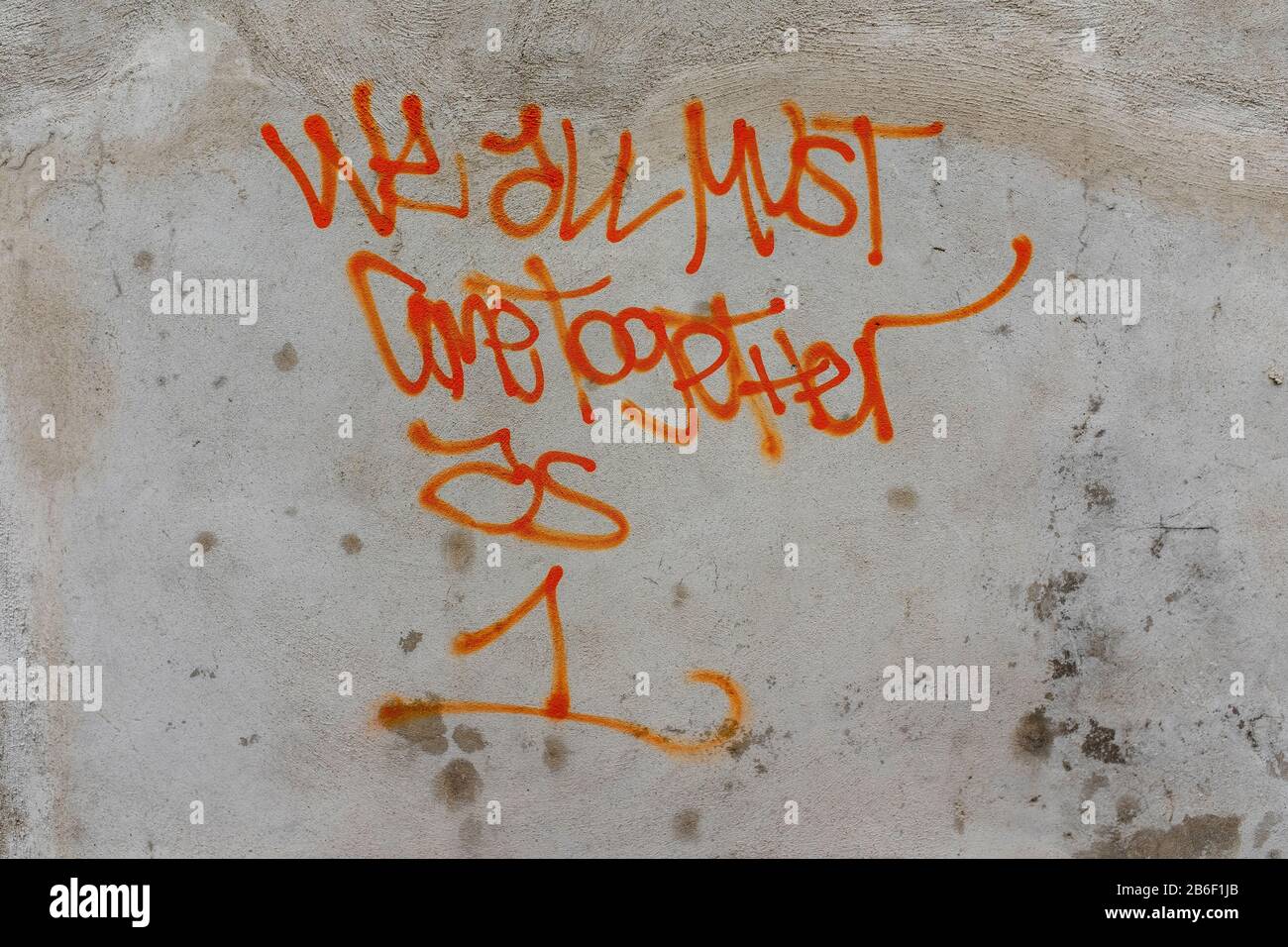 "Wir Müssen Alle Als 1 Zusammenkommen": Graffiti an der Wand in der Gasse (Monticello, N. Y.) Stockfoto