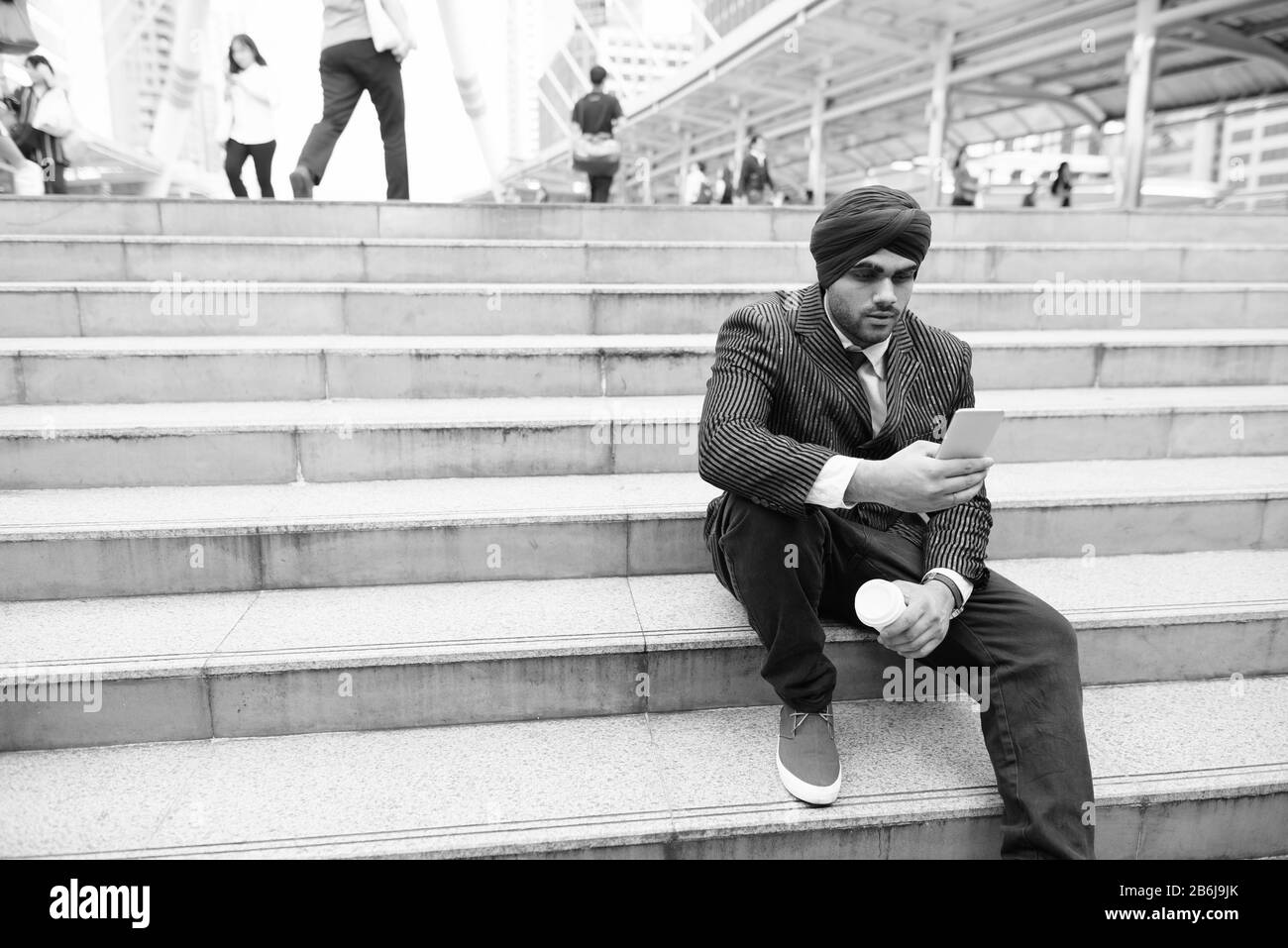 Junger gutaussehender indischer Sikh-Geschäftsmann am Treppenhaus in der Stadt Stockfoto