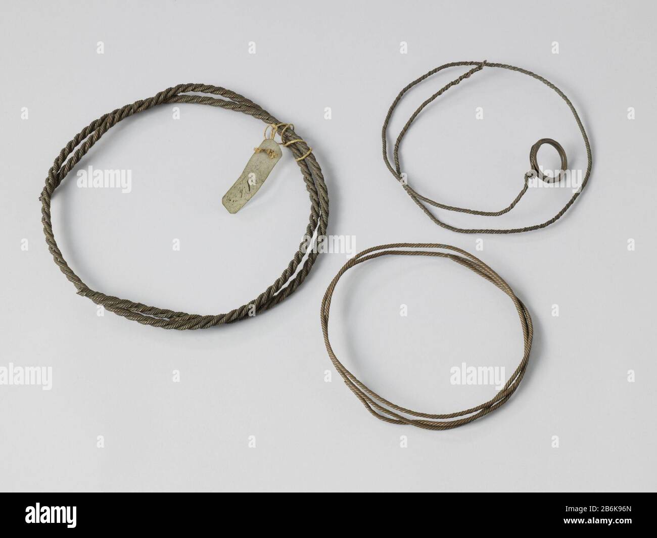 Drei Proben von Donner Chains Drie Monsters van Bliksemafleiders voor schepen in de vorm van koperdraad, alle kabelslag. De twee dunne bestaan uit vijf garens ieder, één met een koperen Ring aan een eind; de dikere donderketing bestaat uit drie stren van vijf garens en en het perkamenten etiket de signatuur van Asmus is eraan bevestid. Hersteller: Vervaardiger: Jochem Pietersz. Asmus (mogelijk)Plaats Herstellung: Nederland dating: 1790-1848 Physische Kenmerken: Koper en perkament Material: Koper Perkament Abmessungen: (1): L 145 cm. (2): L 141 cm. (3): L 95 cm. Stockfoto