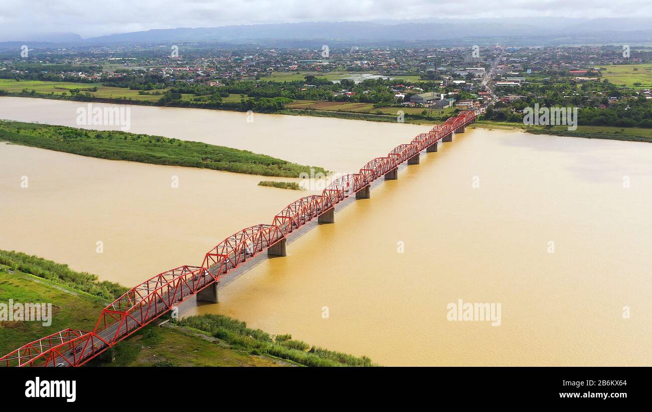 Brücke über den Cagayan River, Philippinen, Luftbild. Straßenbrücke über einen breiten Fluss. Autos fahren auf der Brücke. Stockfoto