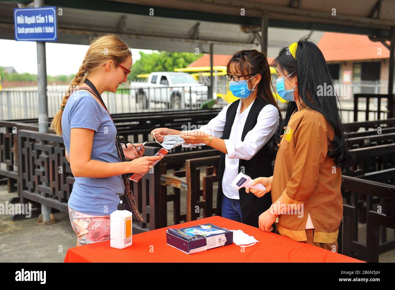 (200311) -- HANOI, 11. März 2020 (Xinhua) -- EIN Personal liefert einem Besucher an einem Touristenort in Vietnams Nordprovinz Ninh Binh am 10. März 2020 eine kostenlose Maske. Vietnams Gesundheitsministerium bestätigte am Mittwoch drei neue COVID-19-Infektionen in seiner zentralen Provinz Binh Thuan und brachte die insgesamt bestätigten Fälle im Land auf 38. (VNA/Handout über Xinhua) Stockfoto