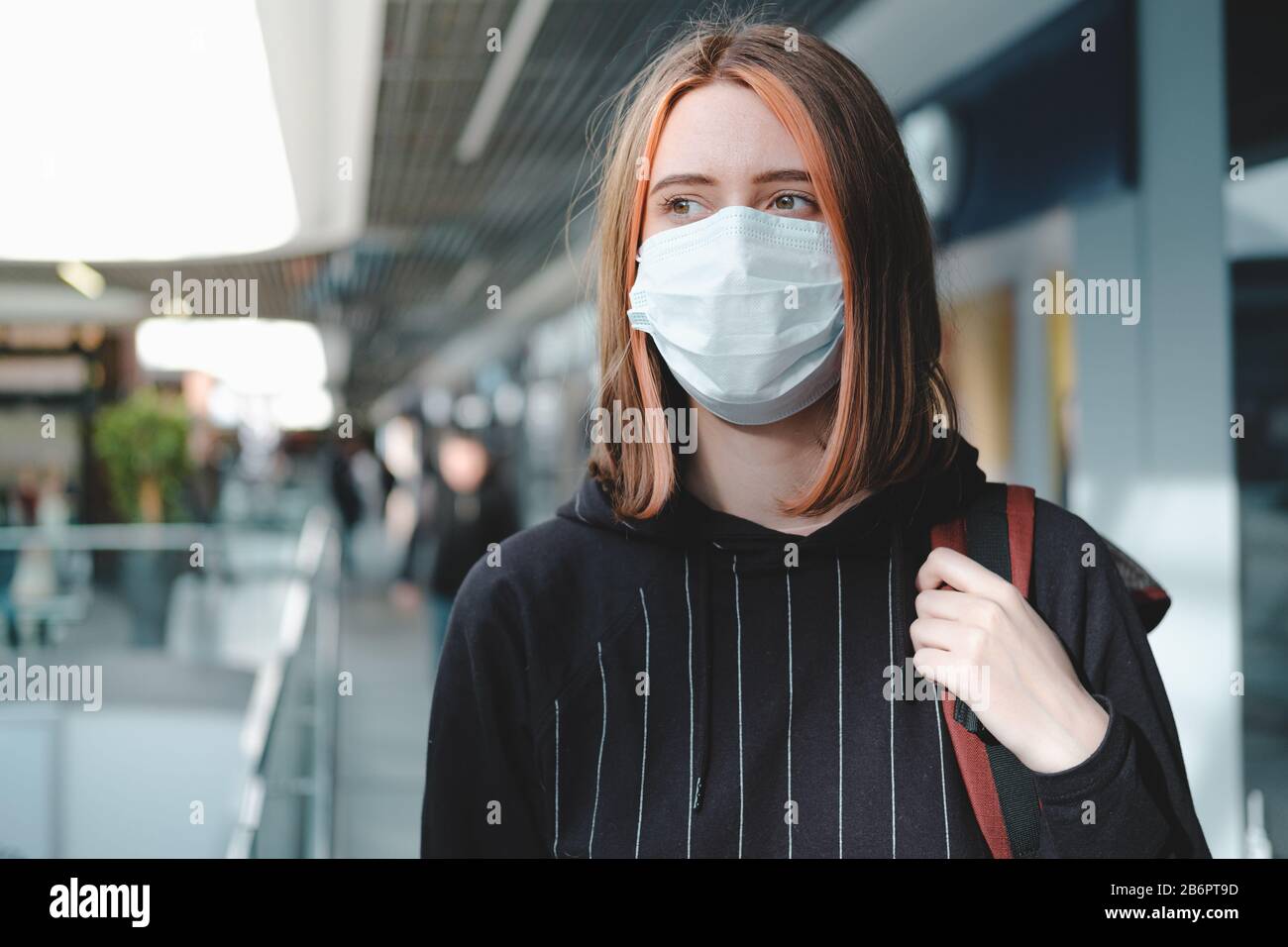 Frau in einer schützenden Gesichtsmaske am öffentlichen Ort. Coronavirus, COVID-19 Spread Prevention Concept, verantwortungsbewusstes Sozialverhalten eines Bürgers Stockfoto