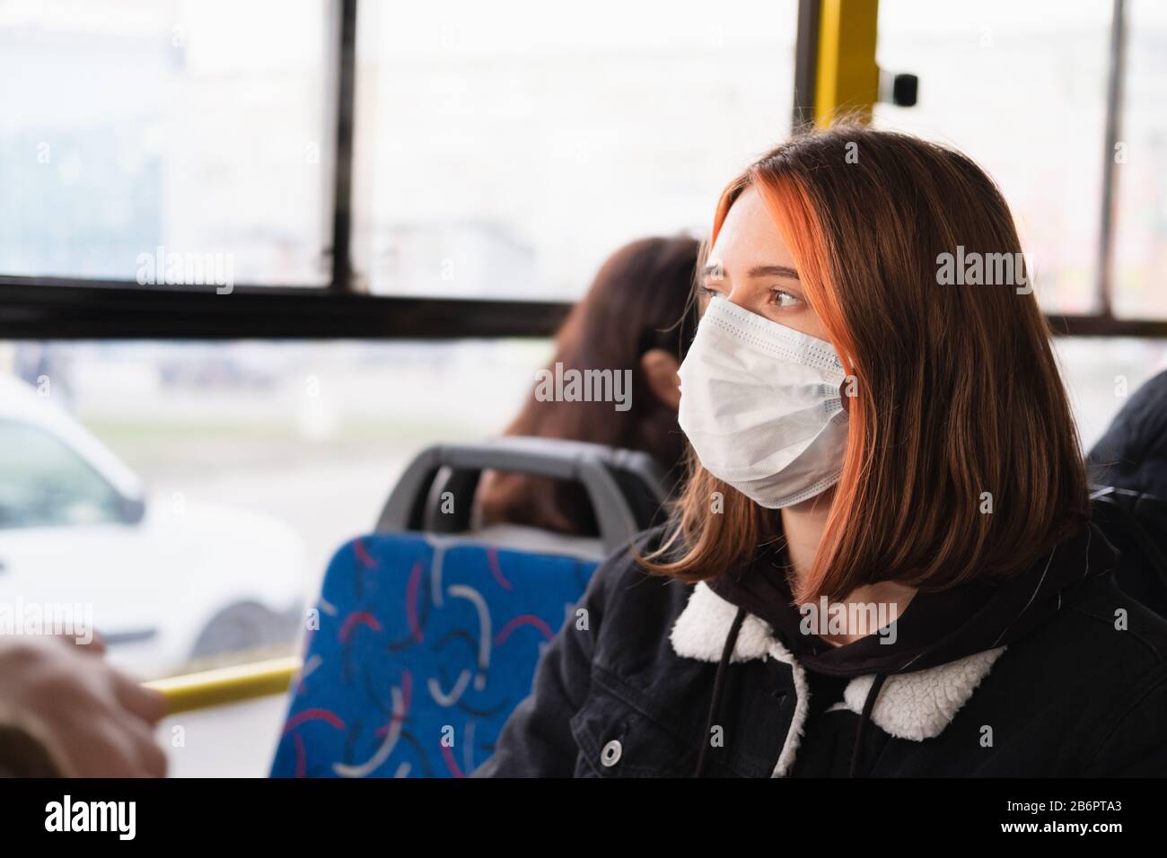 Frau pendelt in einer schützenden Gesichtsmaske. Coronavirus, COVID-19 Spread Prevention Concept, verantwortungsbewusstes Sozialverhalten eines Bürgers Stockfoto