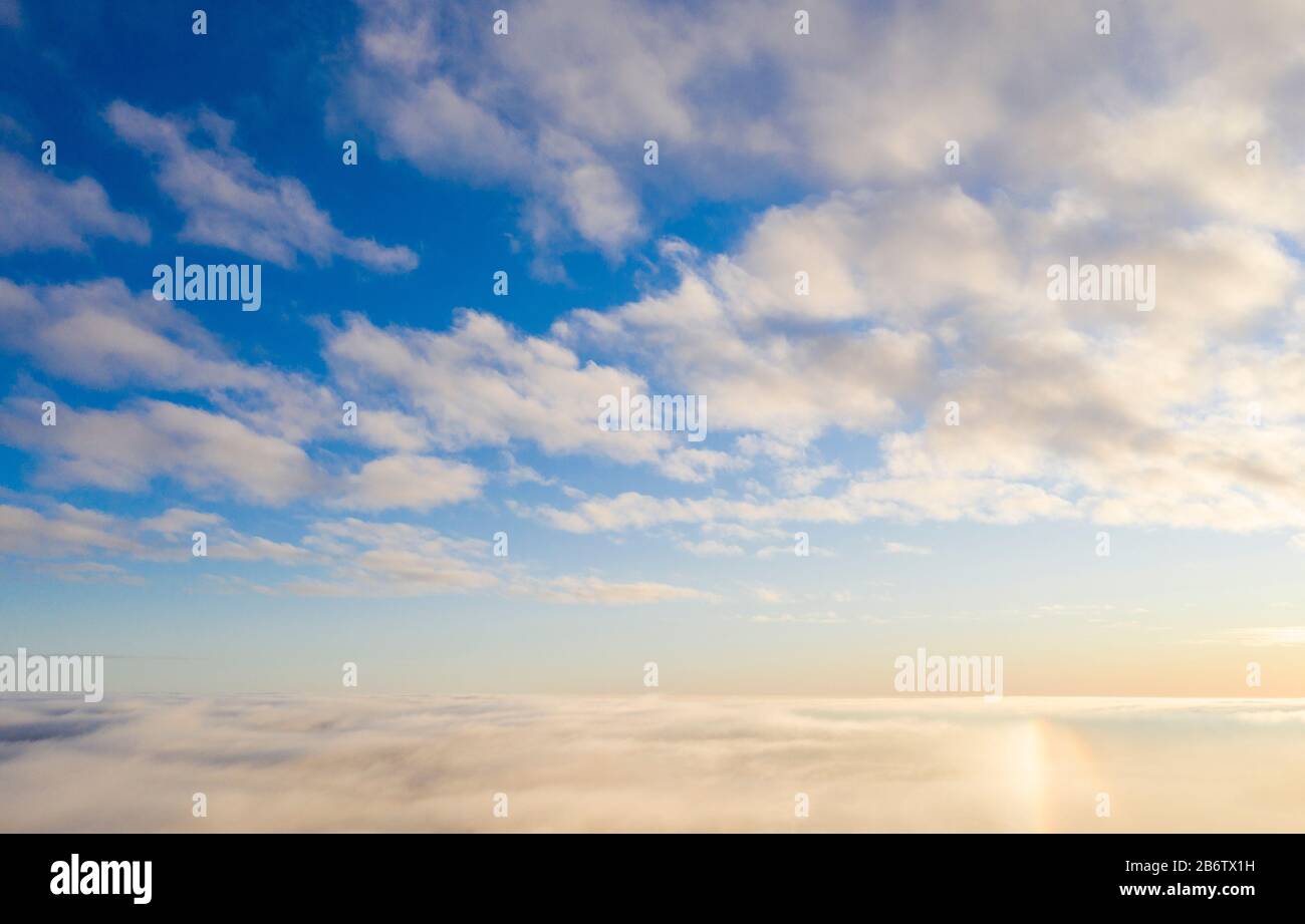 Luftbild Weiße Wolken in blauem Himmel mit Sonnenhalo. Draufsicht. Blick von der Drohne. Vogelperspektive. Luftbild Draufsicht cloudscape. Struktur von Wolken Stockfoto