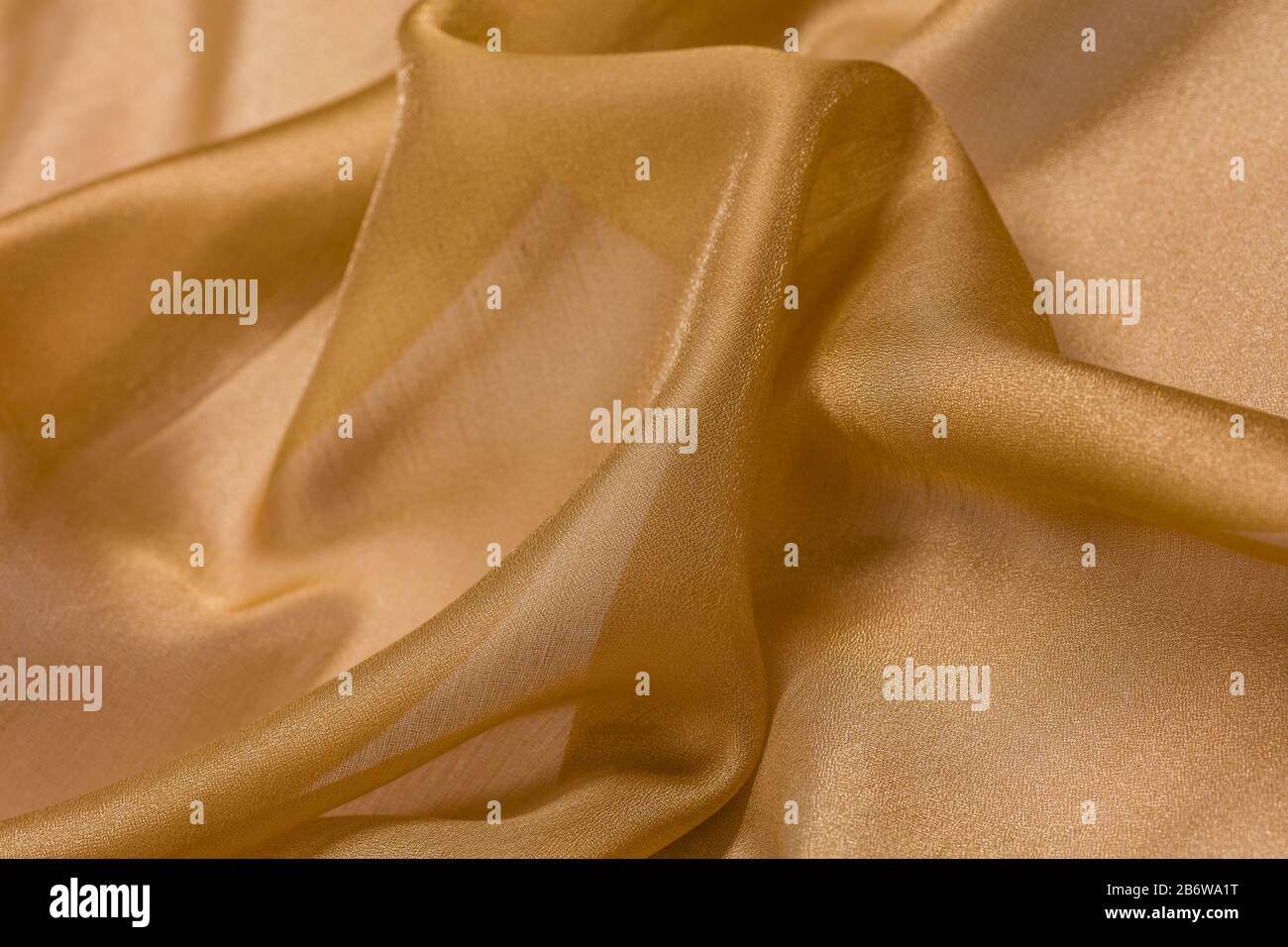 Glänzender Stoffhintergrund mit beigefarbenem Fläschchen Textil Stockfoto