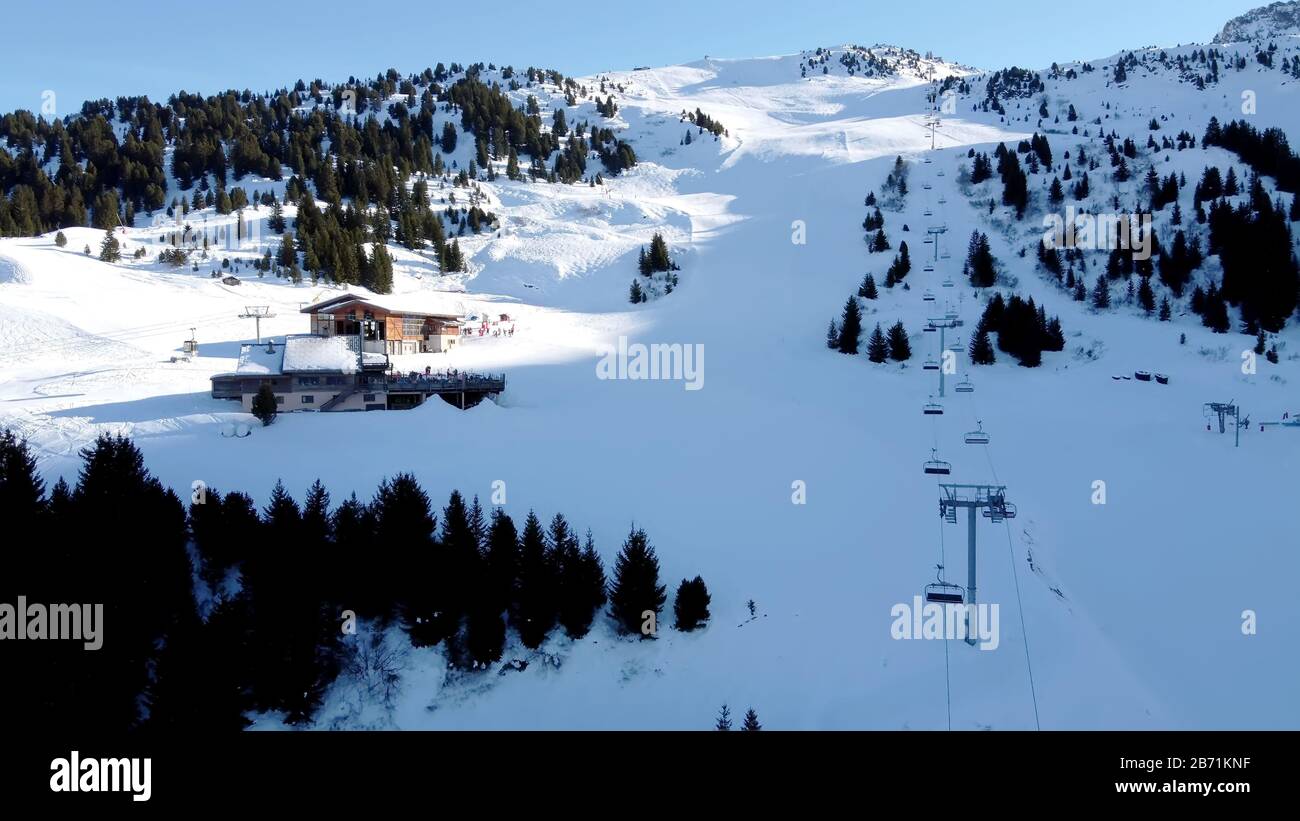 Majestätische Winterlandschaft und Skigebiet mit typisch alpinem Holzhaus in französischen Alpen, Les Menuires, 3 Vallees, Frankreich, Europa Stockfoto