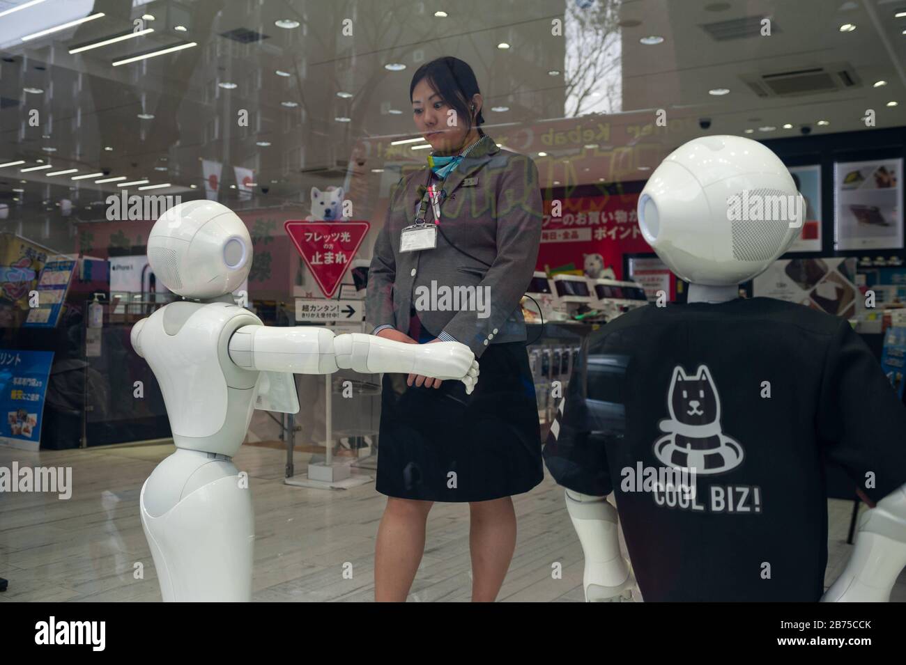 31.12.2017, Tokio, Japan, Asien - EINE Verkäuferin hat Augenkontakt mit einem halbhumanoiden Roboter der Pepper-Serie in einem Spezialitätengeschäft im Bezirk Shibuya. Der Pepper Roboter wird von SoftBank Robotics hergestellt und kann Emotionen erkennen. [Automatisierte Übersetzung] Stockfoto