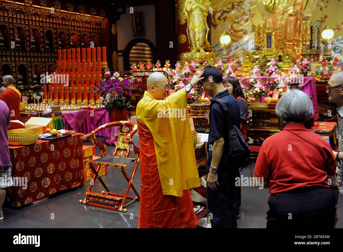 SINGAPUR, 19. Februar 2015 buddhistische Mönch beten und segnen Gläubige am ersten Tag der mehrtägigen chinesischen Neujahrsfeierlichkeiten im Buddha-Zahnrelikempel in Singapurs Chinatown. Das neue Jahr basiert auf dem chinesischen Mondkalender und steht unter dem Zeichen der Schafe oder der Ziege. Der Tempel ist eine der vielen Sehenswürdigkeiten des Stadtstaats, von denen drei Viertel aus Menschen chinesischer Abstammung bestehen. [Automatisierte Übersetzung] Stockfoto