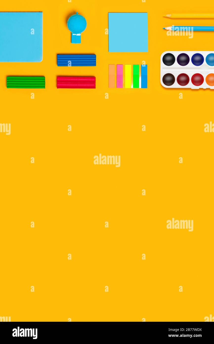 Schulbedarf auf gelbem vertikalem Hintergrund. Zurück zum Schulbild. Stockfoto