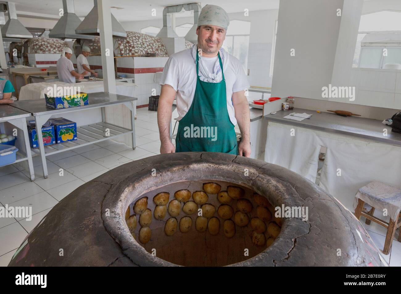 Usbekischer Hersteller backt lokales Gebäck, bekannt als Samsa, in Chorsu Bazaar, Taschkent, Usbekistan. Stockfoto