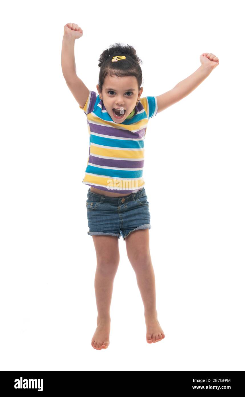 Happy Excited Girl Jumping in The Air Isoliert auf weißem Hintergrund Stockfoto