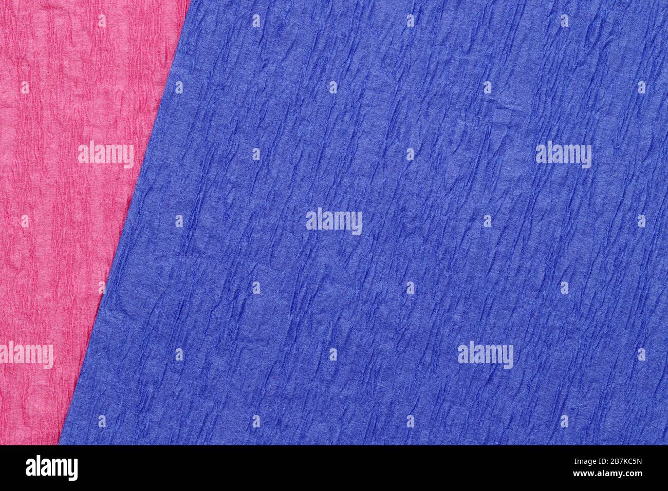 Rauer und zerknitterter Texturhintergrund aus blauem und rosafarbenem Farbpapier Stockfoto
