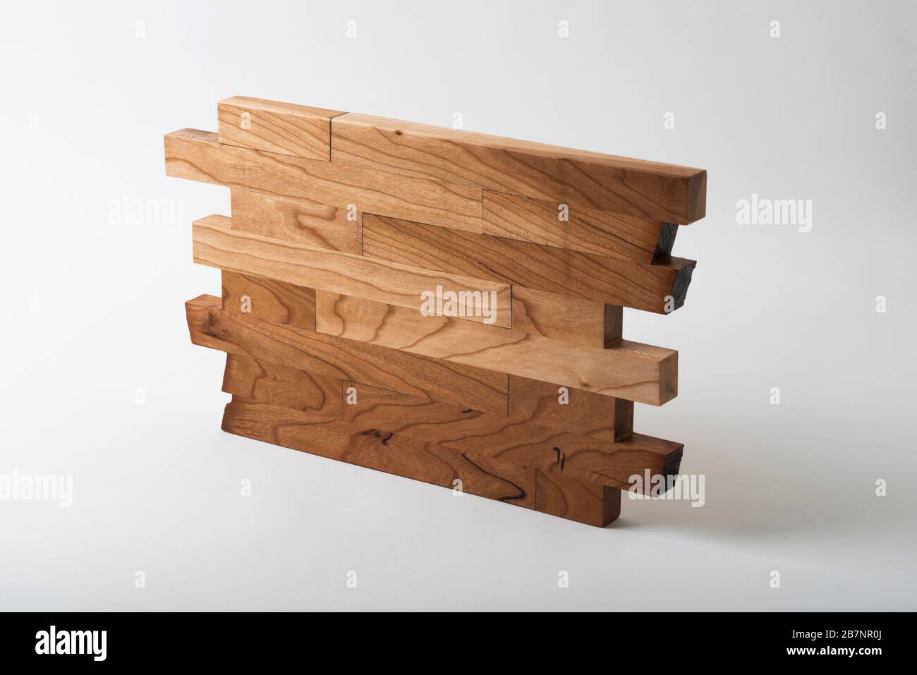 Eine handgefertigte Holzniete aus Kirschholz für den Einsatz auf einem Esstisch unter warmen Speisen. Stockfoto