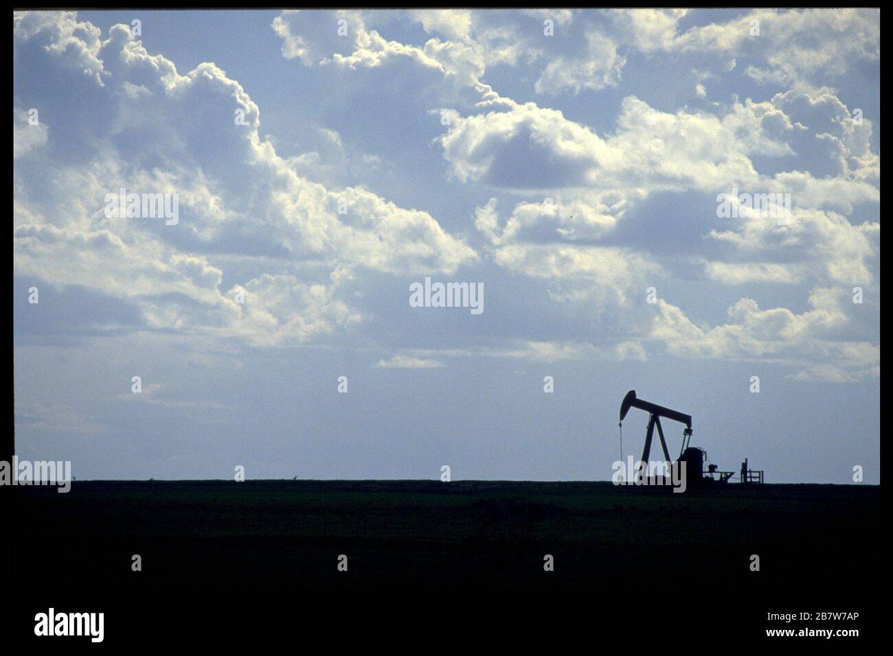 Ölextrahierende Kürbisse, die in der baumlosen Küstenebene in der Nähe von Corpus Christi Texas vor Himmel und Wolken geschildet wurden. ©Bob Daemmrich Stockfoto