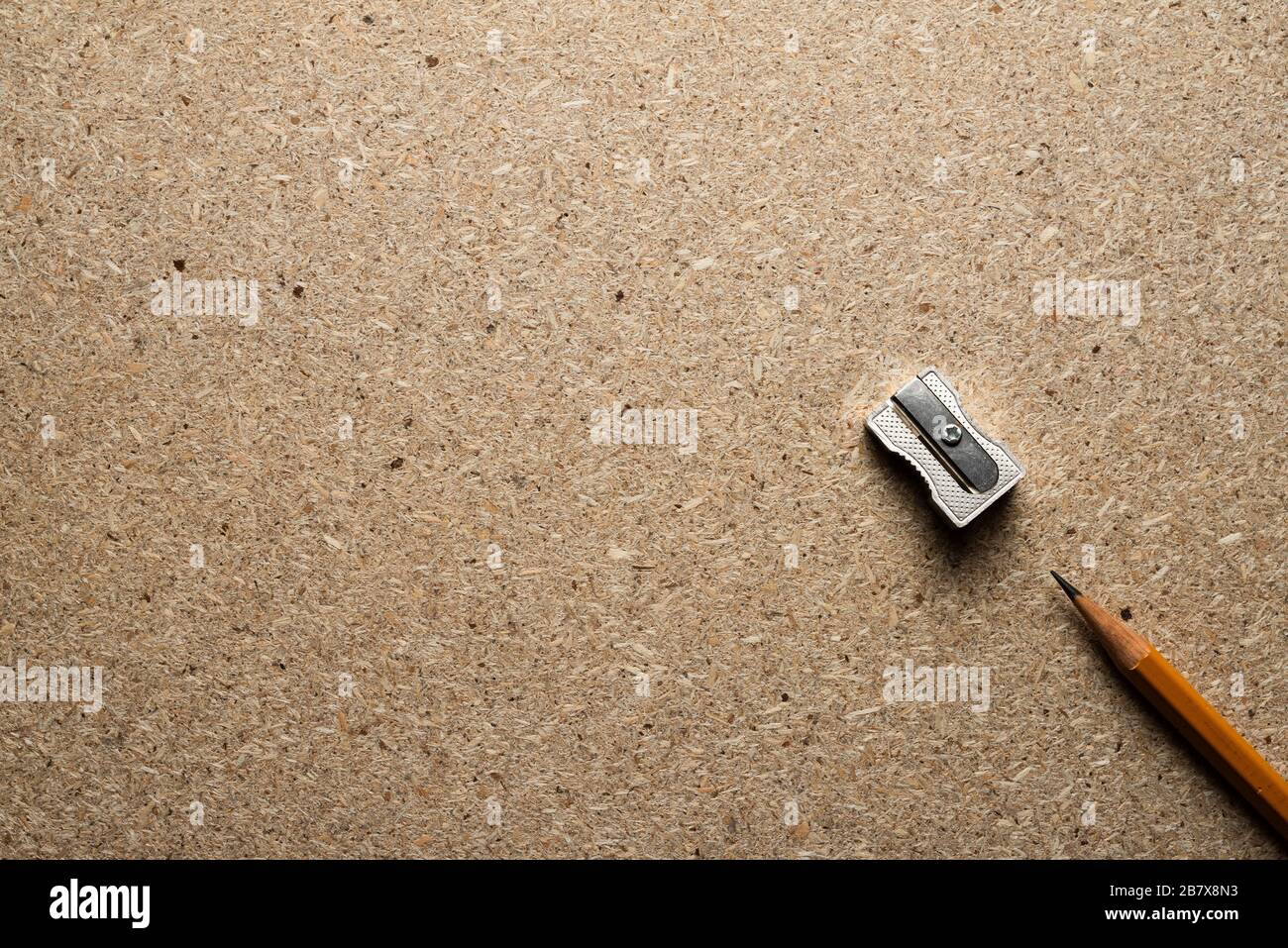 Bleistift und Schärfer auf einer Spanplatte. Draufsicht. Stockfoto