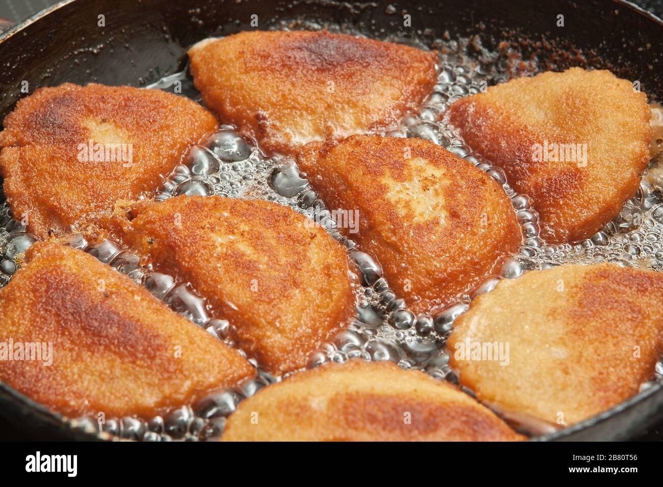 Patties mit Kalamären in Butter in einer Bratpfanne. Stockfoto