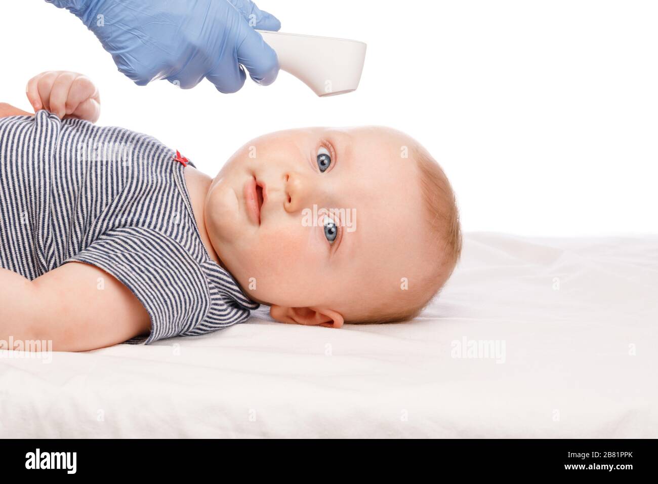 Kinderarzt oder Krankenschwester überprüft die Körpertemperatur des Jungen mithilfe eines Infrarot-Stirnthermometers (Thermometerpistole) auf das Symptom einer Krankheit Stockfoto