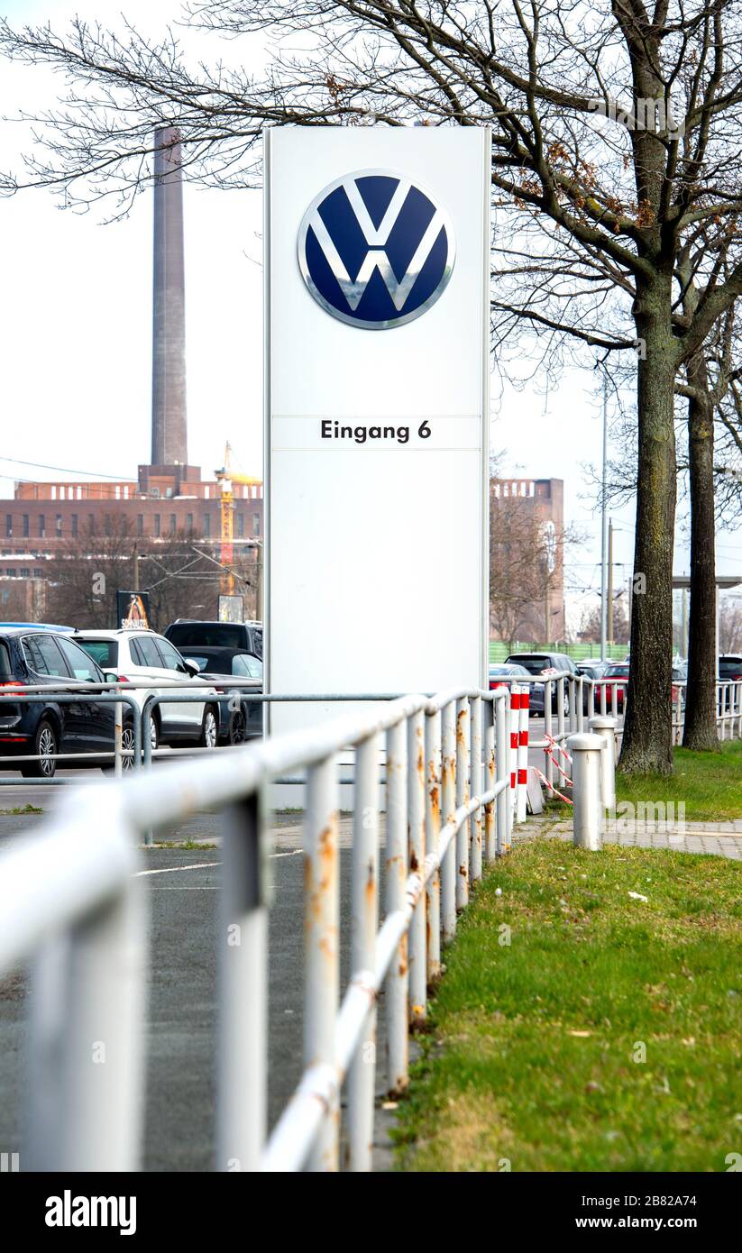 19. März 2020, Niedersachsen, Wolfsburg: Das Logo der Volkswagen AG befindet sich am Eingang eines Mitarbeiterparkplatzes vor dem Werk. Das wachsende Infektionsrisiko und die drastischen wirtschaftlichen Folgen der Coronakrise werden Volkswagen ab Donnerstagabend (19. März 2020) zur Schließung seiner Werke in Deutschland zwingen. Foto: Hauke-Christian Ditrich / dpa Stockfoto