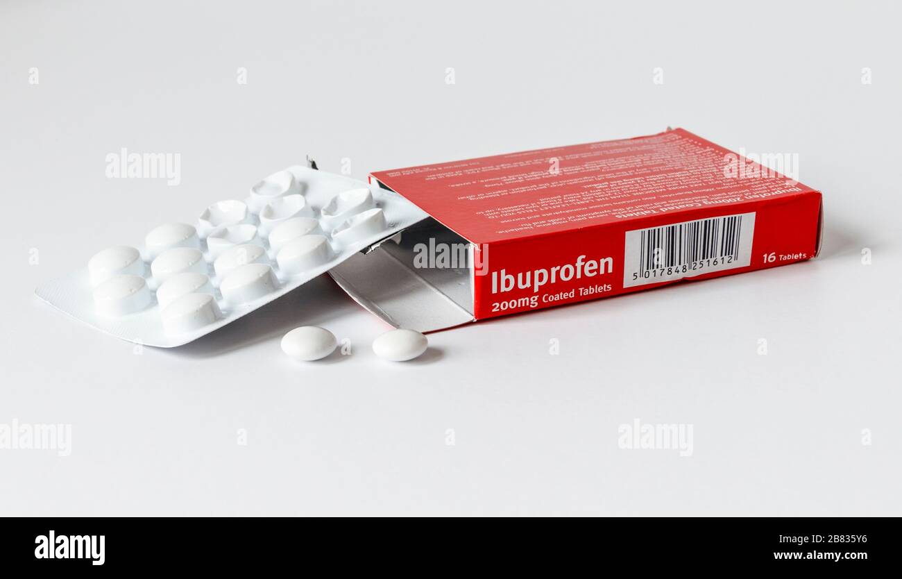 Ibuprofen-Tabletten in einer Blisterpackung, aus der zwei Tabletten entfernt werden, auf weißem Hintergrund Stockfoto