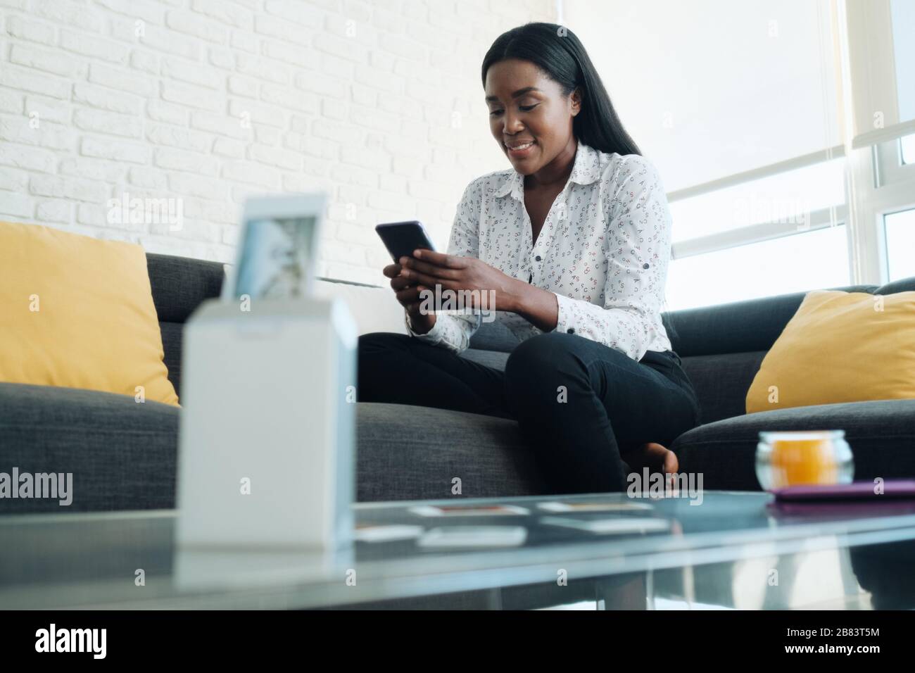 Black Woman Mit Tragbarem Wi-Fi-Drucker Zum Drucken Von Bildern Stockfoto