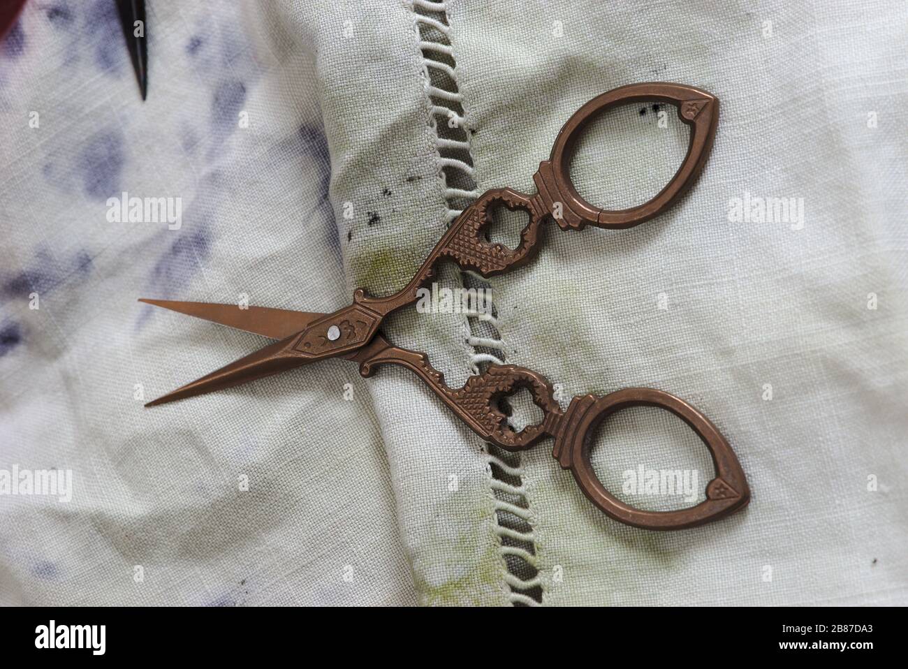 Alte Nähschere und alte bedruckte Stoffe Stockfoto