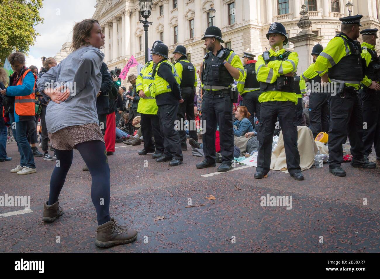 London, Großbritannien. - 9. Oktober 2019- Aufregungsrebellion Klimaschutzprotest - ein weiblicher Protestler tanzt vor Polizisten Stockfoto