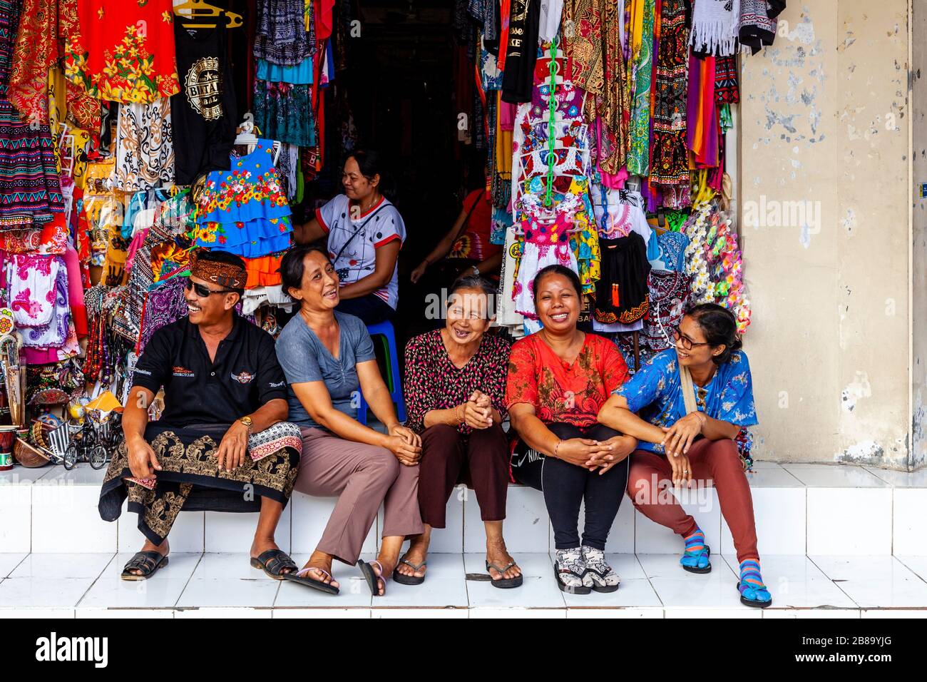 Eine Gruppe von Einheimischen, die vor EINEM Souvenirladen sitzen, Sukawati Art Market, Gianyar, Bali, Indonesien. Stockfoto