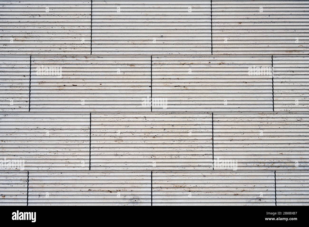 Hintergrund aus einer Wand aus beigefarbenen Granitplatten Stockfoto