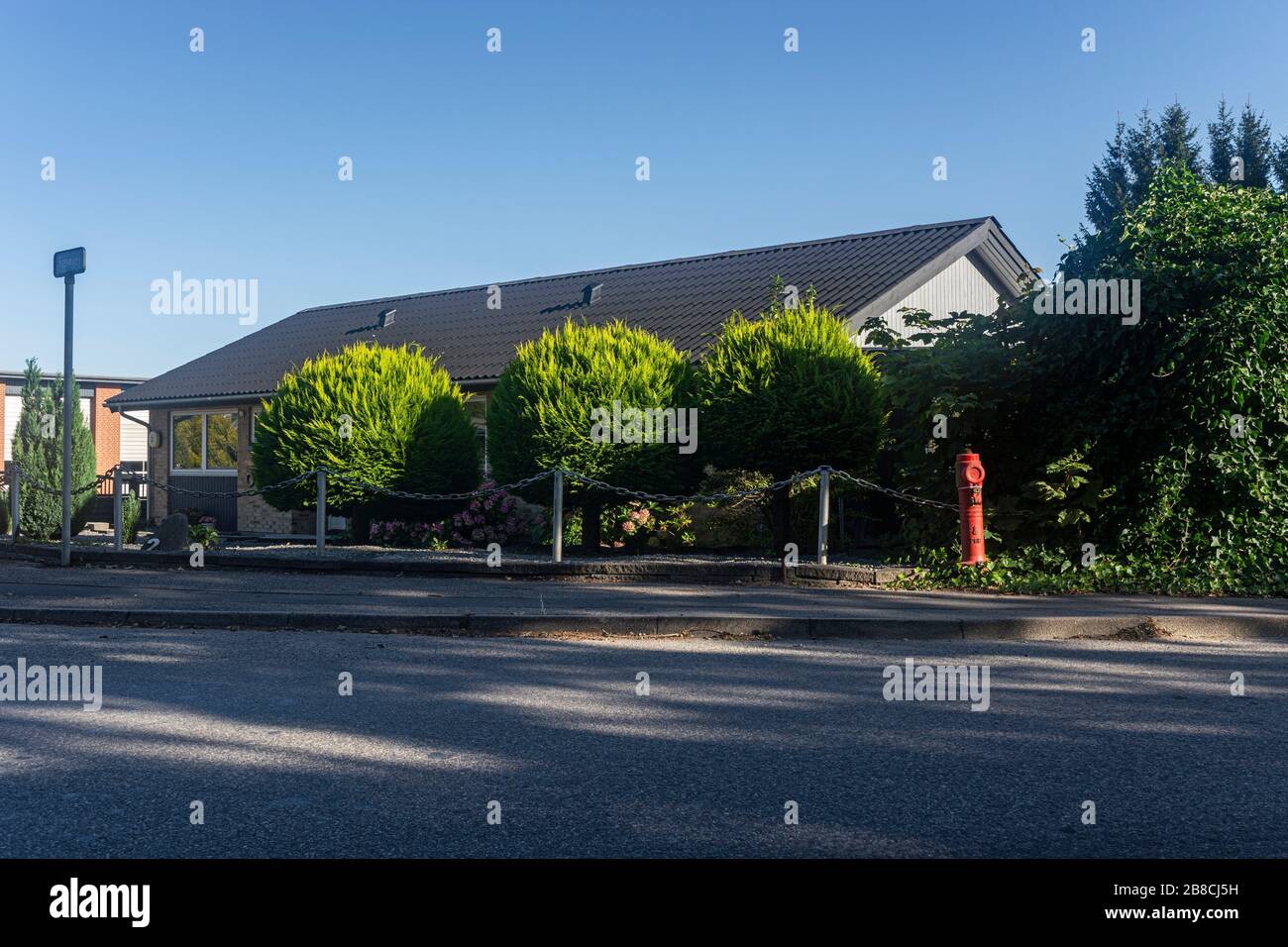 Landhaus mit Bäumen und Zaun Dänemark Stockfoto